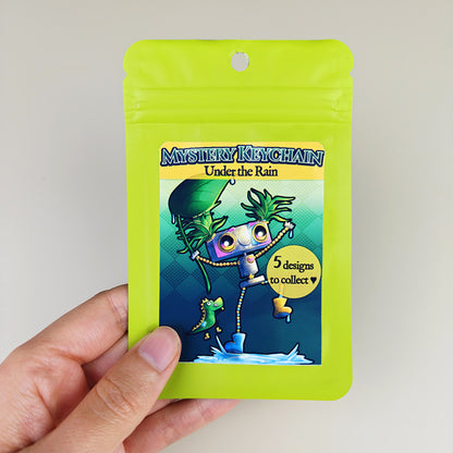 Porte-clés mystère Robots sous la pluie – 4 designs + 1 secret - Pixy & Mochi, Sparky, Vivy, Oliver (La Clairière des Âmes ferrées)